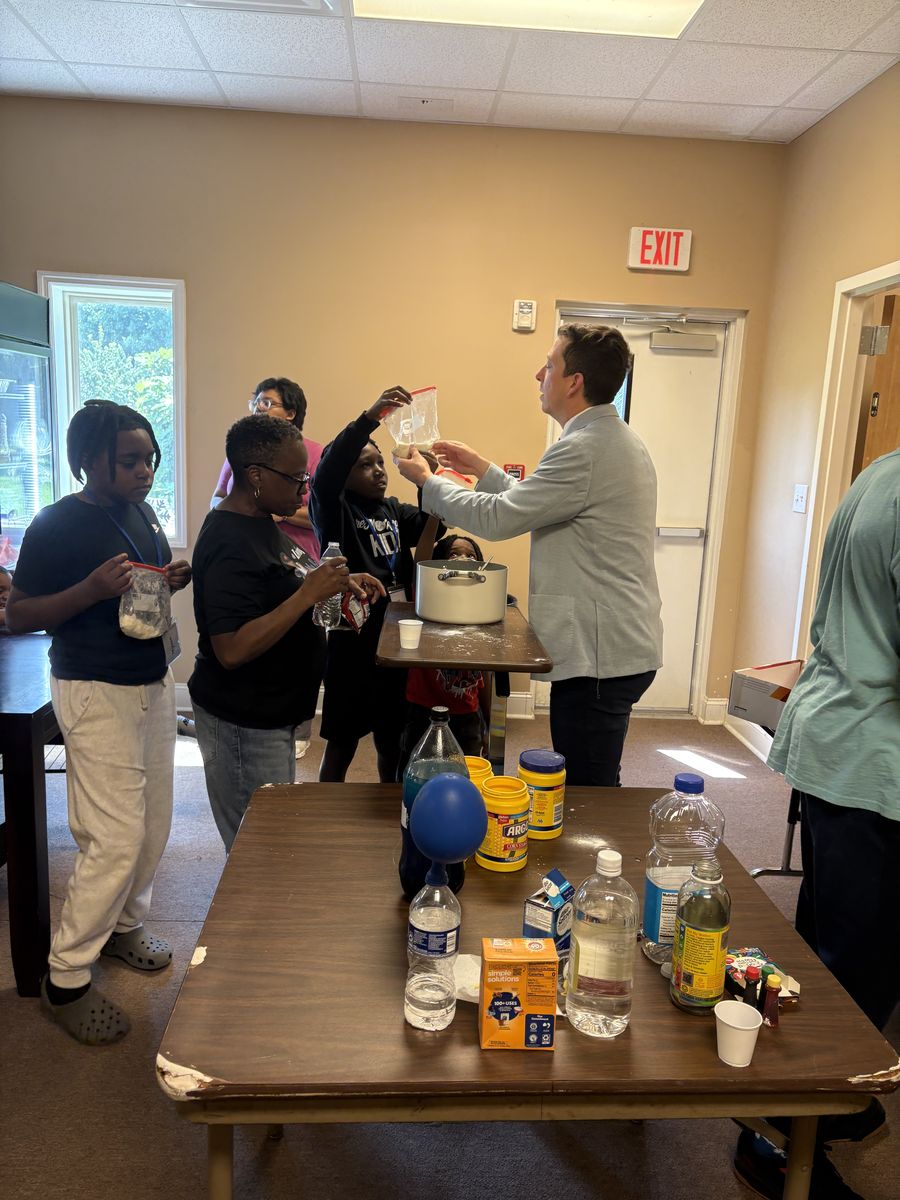 Campers watching a hands-on science experiment in the fellowship hall